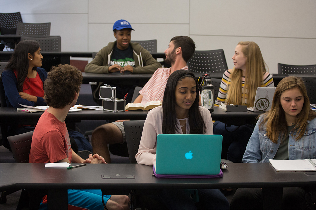 GW English Department Undergraduate Programs graphic with six students sitting in 3 rows in a classroom.