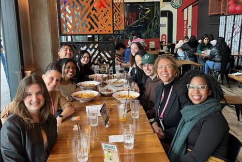 A group of people sitting around a table together