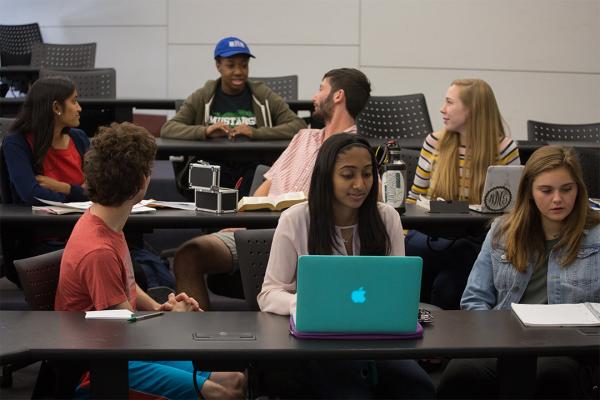 GW English Department Undergraduate Programs graphic with six students sitting in 3 rows in a classroom.