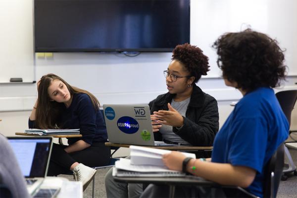 GW Department of English 3 students discussing in a classroom